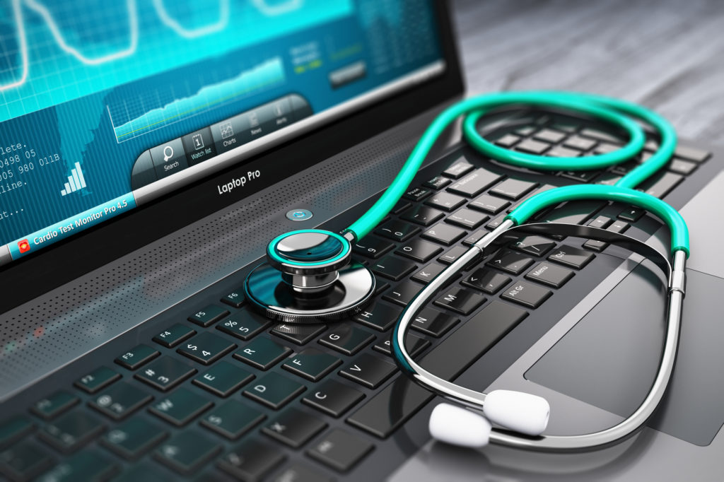 Insurance Companies & Personal Injury - Laptop with medical diagnostic software and stethoscope